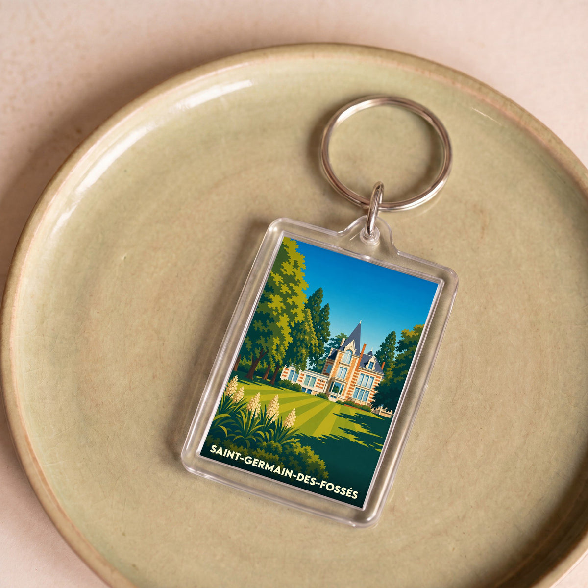 Porte-clés souvenir de la ville de Saint-Germain-des-Fossés avec une illustration stylisée.