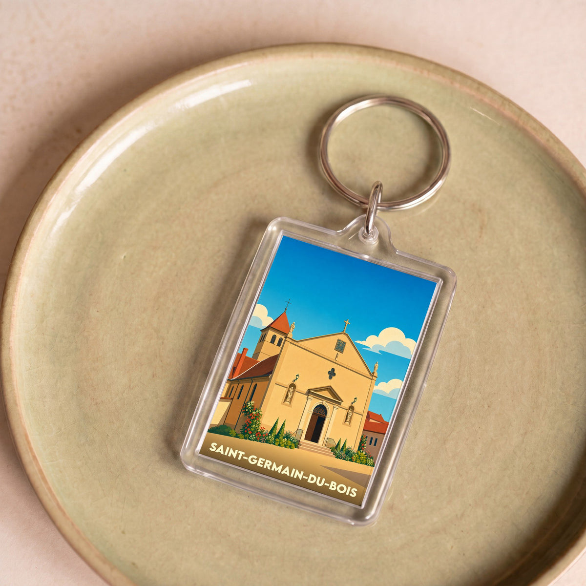 Porte-clés souvenir de la ville de Saint-Germain-du-Bois avec une illustration stylisée de son église.