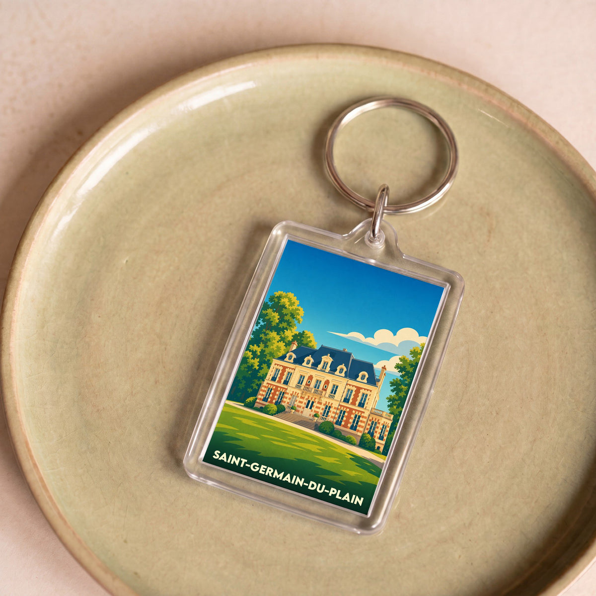 Porte-clés souvenir de la ville de Saint-Germain-du-Plain avec une illustration stylisée d'un château.