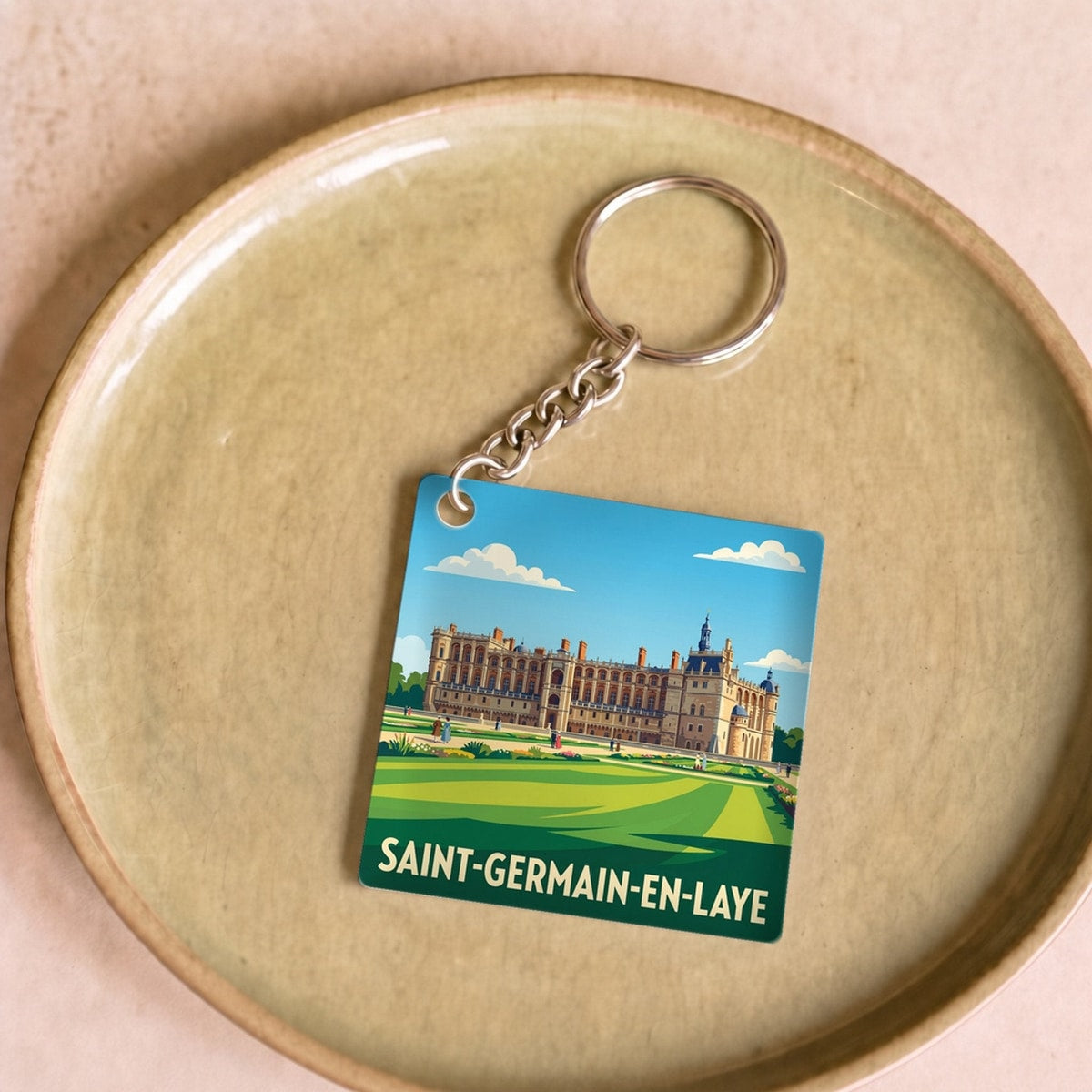 Porte-clés souvenir de la ville de Saint-Germain-en-Laye avec une illustration stylisée.