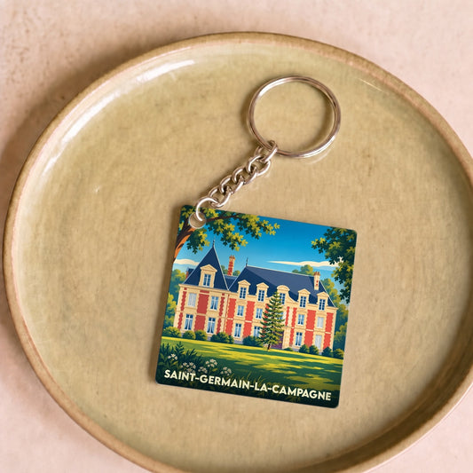 Porte-clés souvenir de la ville de Saint-Germain-la-Campagne illustré d'un manoir coloré.