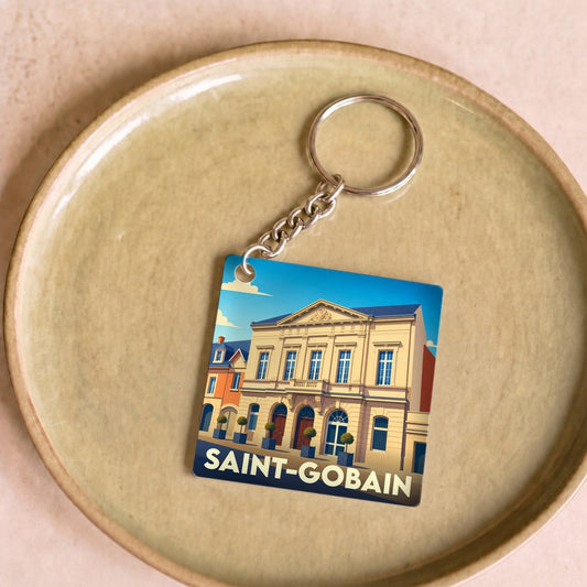 Porte-clés souvenir de la ville de Saint-Gobain avec une illustration stylisée de son patrimoine architectural.