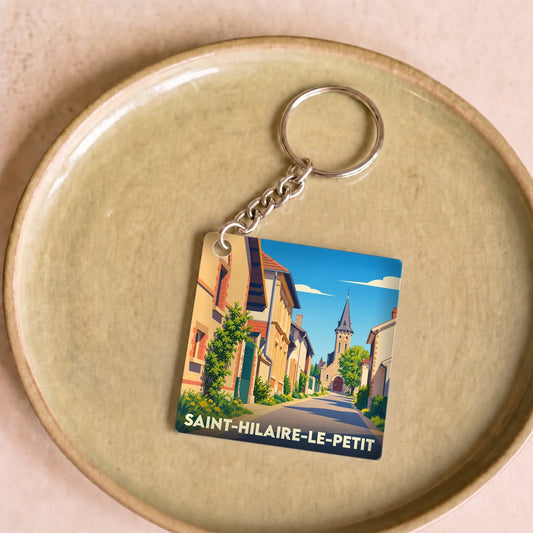 Porte-clés souvenir de la ville de Saint-Hilaire-le-Petit avec une illustration stylisée.