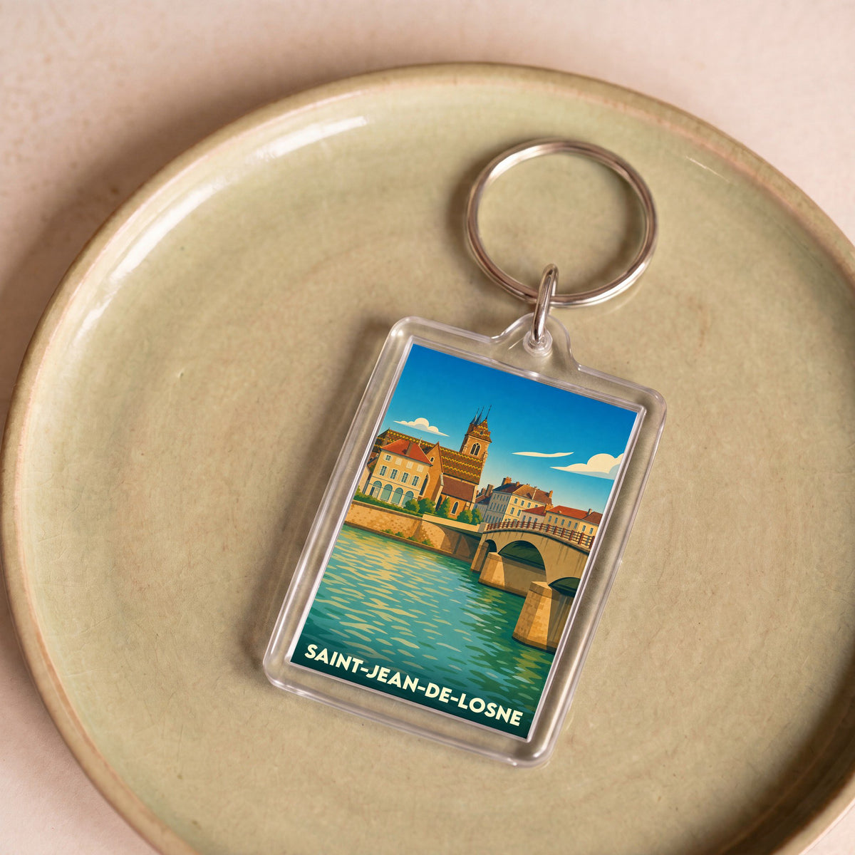 Porte-clés souvenir de la ville de Saint-Jean-de-Losne avec une illustration stylisée.