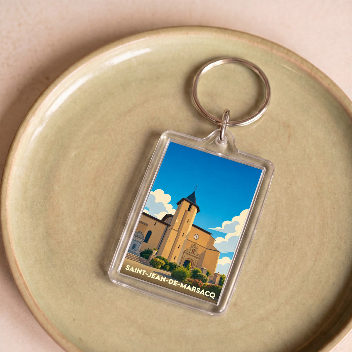 Porte-clés souvenir de la ville de Saint-Jean-de-Marsacq avec une illustration stylisée de son église.