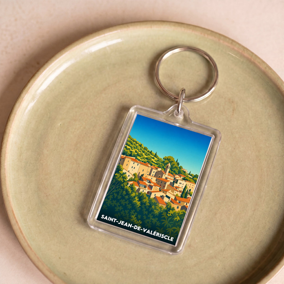 Porte-clés souvenir de la ville de Saint-Jean-de-Valériscle avec une illustration stylisée.