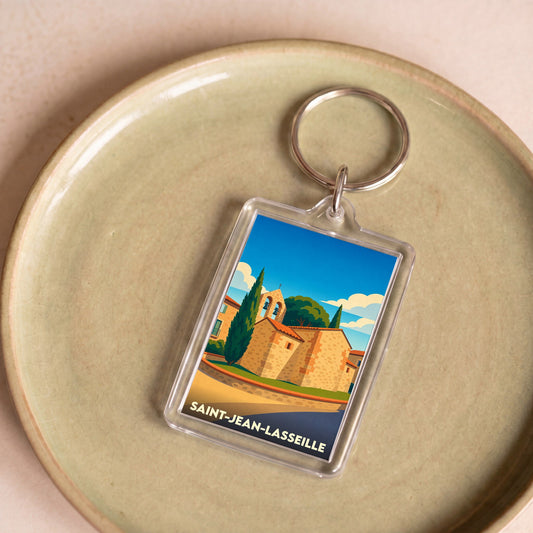 Porte-clés souvenir de la ville de Saint-Jean-Lasseille avec une illustration stylisée de son église.