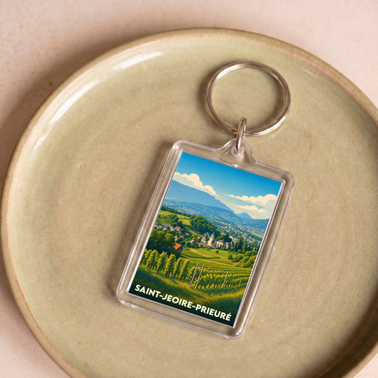 Porte-clés souvenir de la ville de Saint-Jeoire-Prieuré avec une illustration stylisée de ses vignobles et montagnes.