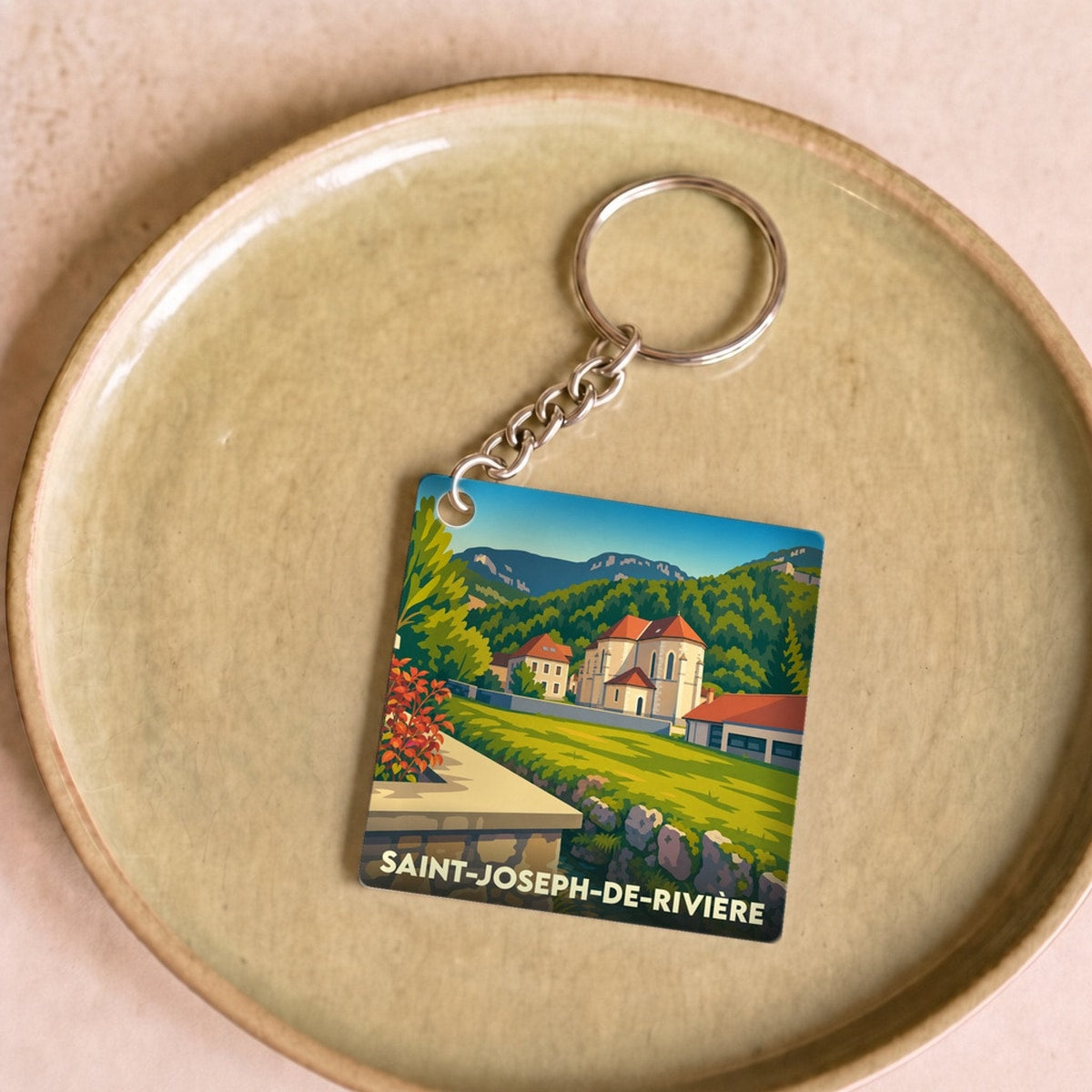 Porte-clés souvenir de la ville de Saint-Joseph-de-Rivière avec une illustration stylisée.