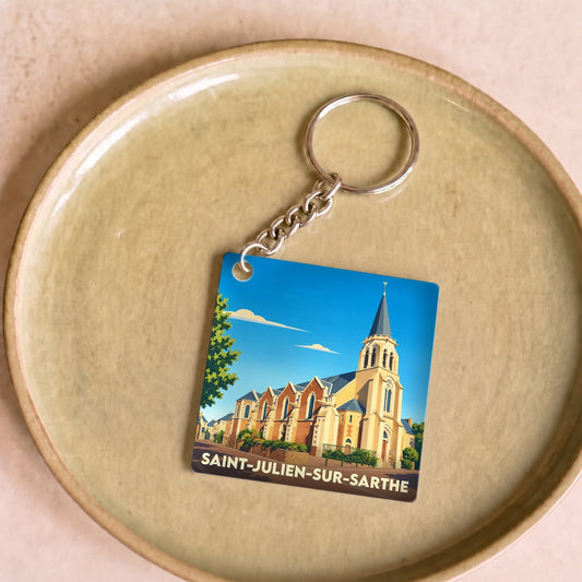 Porte-clés souvenir de la ville de Saint-Julien-sur-Sarthe avec une illustration stylisée de son église.