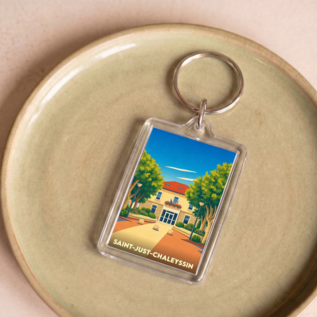 Porte-clés souvenir de la ville de Saint-Just-Chaleyssin avec une illustration stylisée.