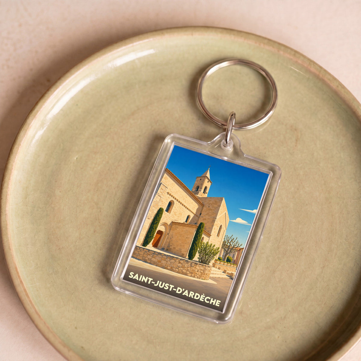 Porte-clés souvenir de la ville de Saint-Just-d'Ardèche avec une illustration stylisée de son église.