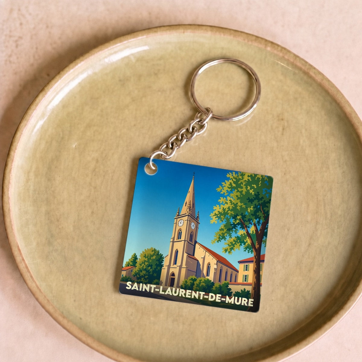 Porte-clés souvenir de la ville de Saint-Laurent-de-Mure avec une illustration stylisée.