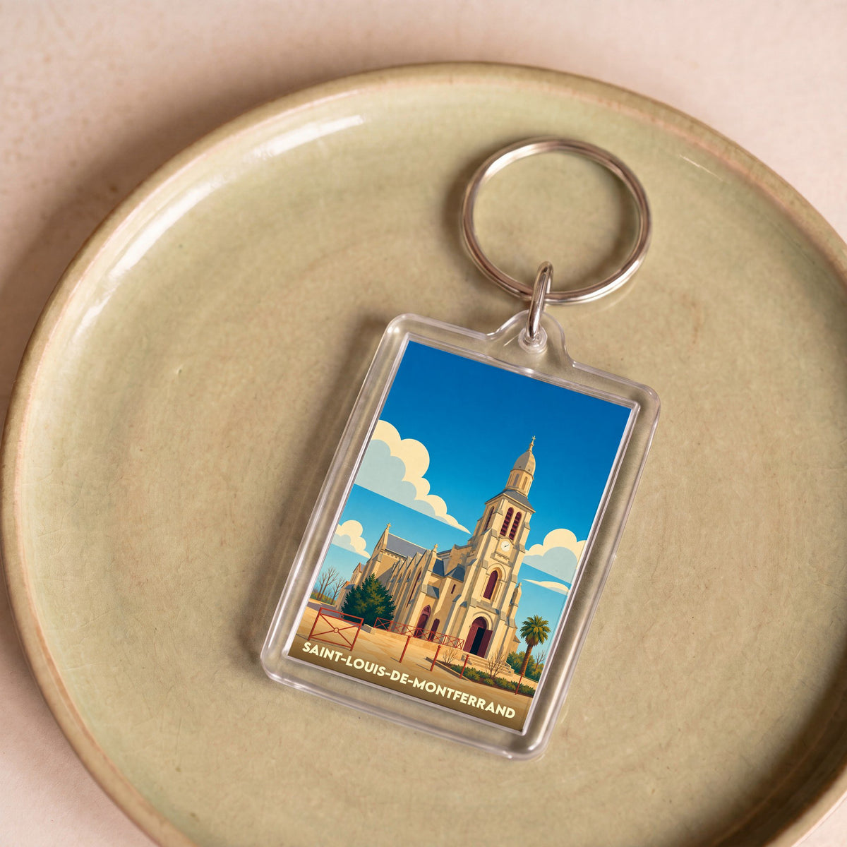 Porte-clés souvenir de la ville de Saint-Louis-de-Montferrand avec une illustration stylisée de son église.