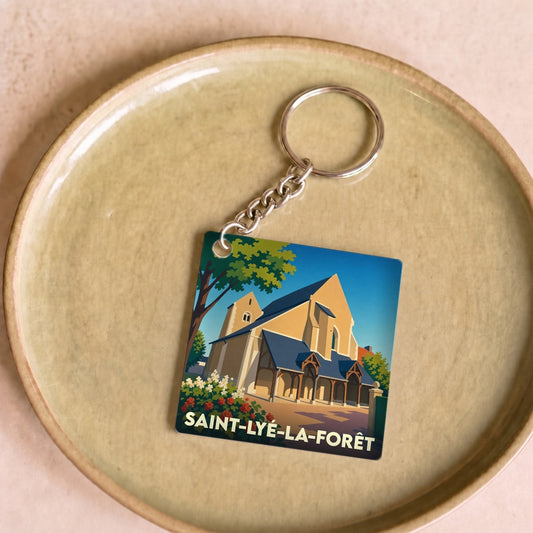Porte-clés souvenir de la ville de Saint-Lyé-la-Forêt avec une illustration stylisée de son église.
