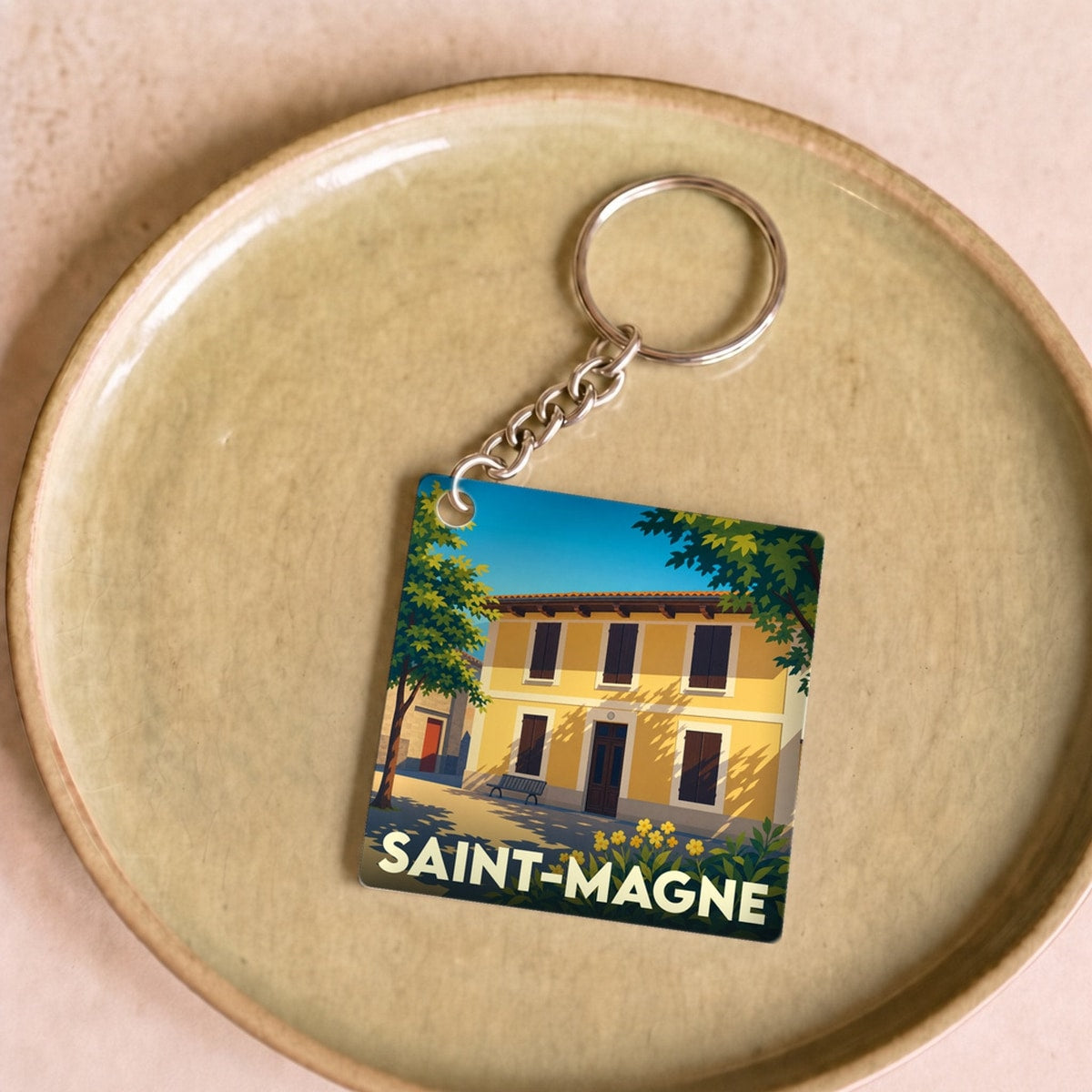 Porte-clés souvenir de la ville de Saint-Magne avec une illustration stylisée.
