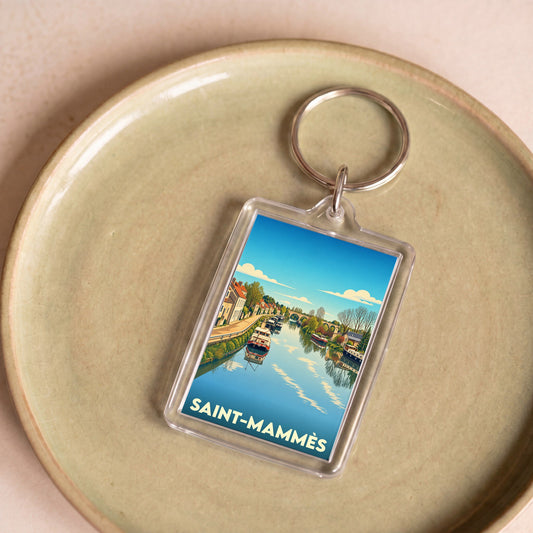 Porte-clés souvenir de la ville de Saint-Mammès avec une illustration stylisée d'un canal et de péniches.