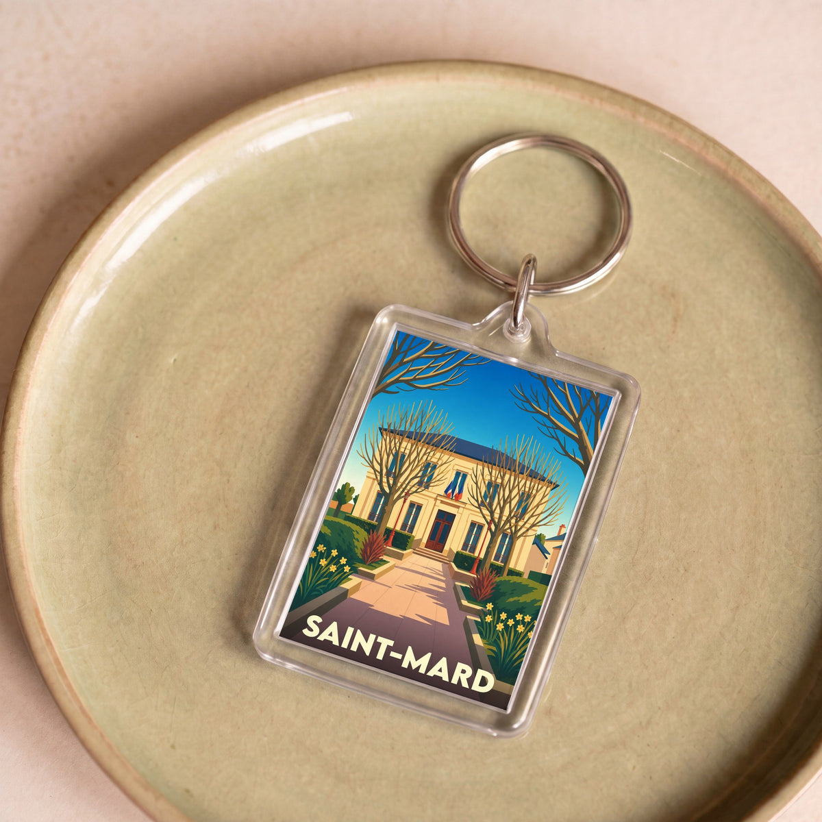 Porte-clés souvenir de la ville de Saint-Mard avec une illustration stylisée de sa mairie.