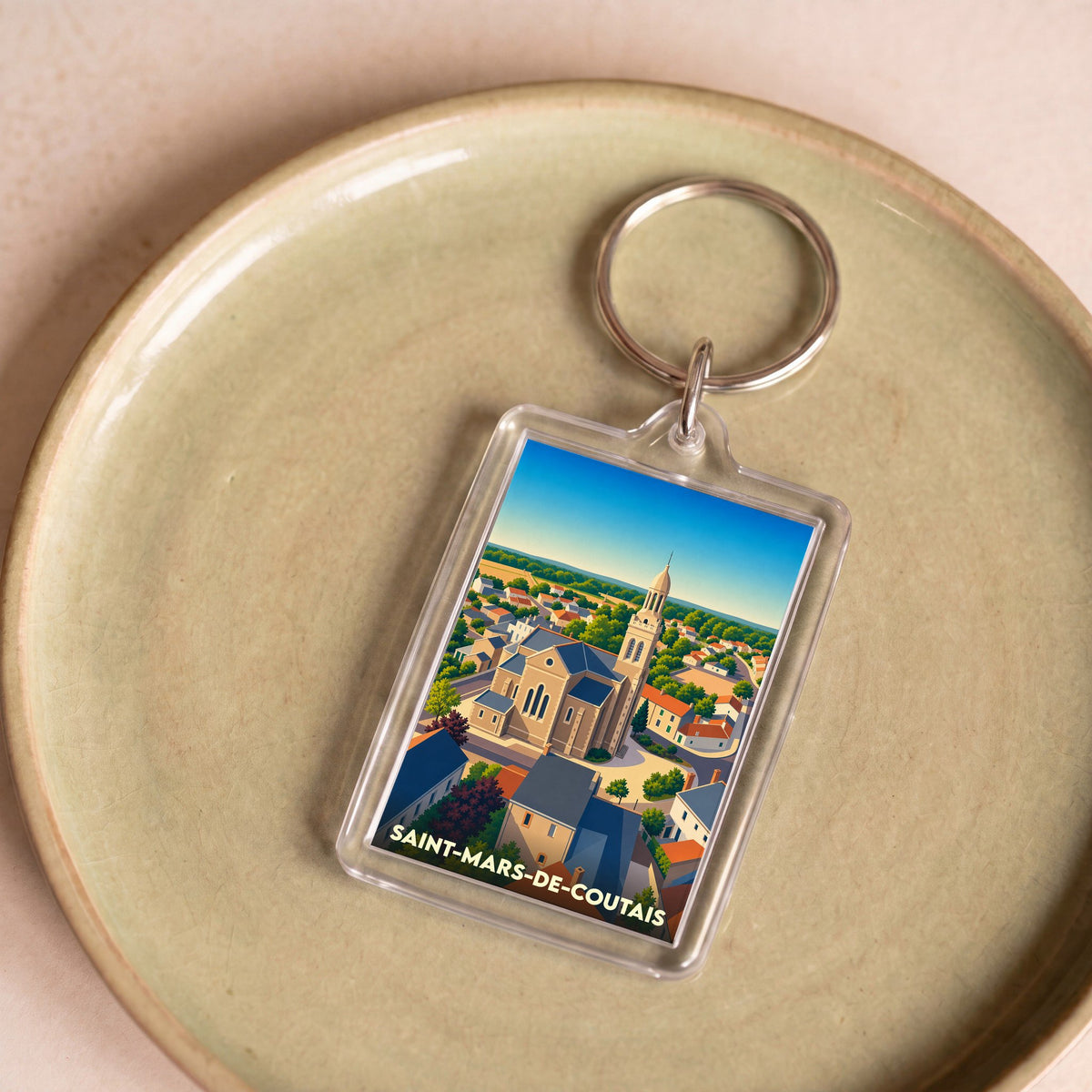 Porte-clés souvenir de la ville de Saint-Mars-de-Coutais avec une illustration stylisée.