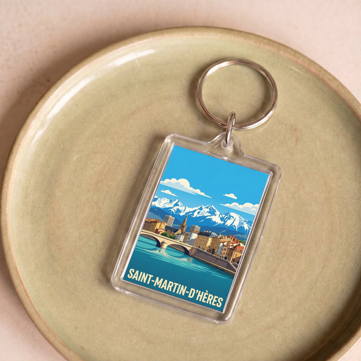 Porte-clés souvenir de la ville de Saint-Martin-d'Hères avec une illustration stylisée.