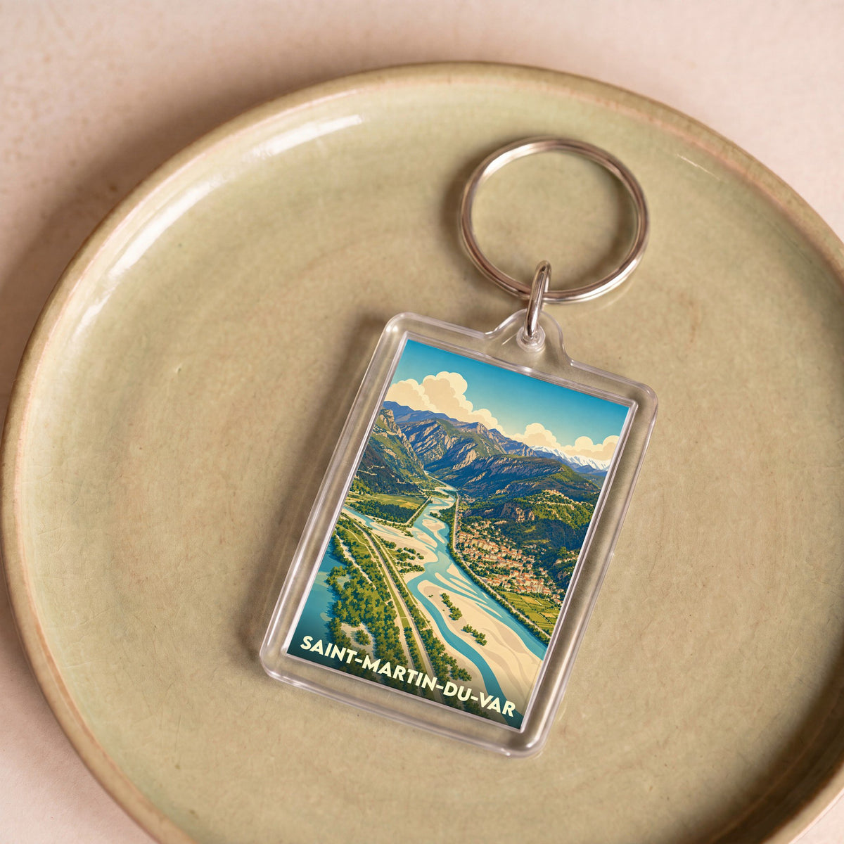 Porte-clés souvenir de la ville de Saint-Martin-du-Var avec une illustration panoramique de la vallée.