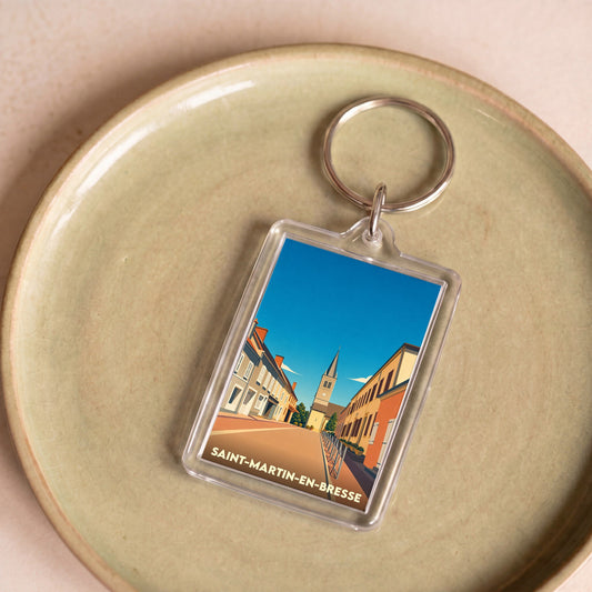 Porte-clés souvenir de la ville de Saint-Martin-en-Bresse avec une illustration stylisée.