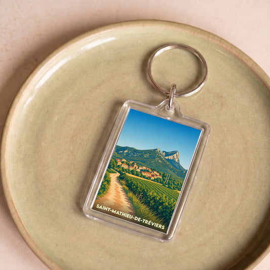 Porte-clés souvenir de la ville de Saint-Mathieu-de-Tréviers avec une illustration stylisée.