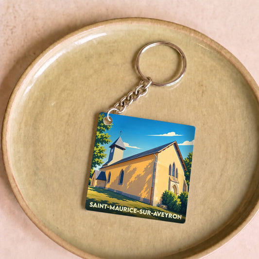 Porte-clés souvenir de la ville de Saint-Maurice-sur-Aveyron illustrant son église dans un style graphique épuré.