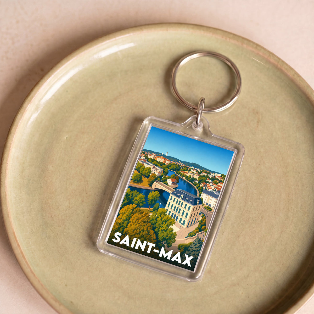 Porte-clés souvenir de la ville de Saint-Max avec une illustration stylisée.