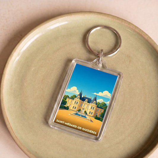 Porte-clés souvenir de la ville de Saint-Médard-de-Guizières avec une illustration stylisée d'un château.