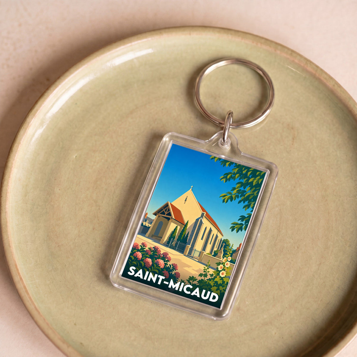 Porte-clés souvenir de la ville de Saint-Micaud avec une illustration stylisée de son église.