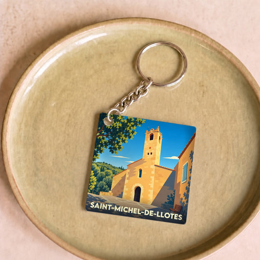 Porte-clés souvenir de la ville de Saint-Michel-de-Llotes avec une illustration stylisée de son église.