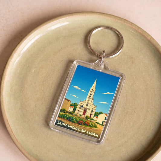Porte-clés souvenir de la ville de Saint-Michel-en-l'Herm avec une illustration stylisée de son église.