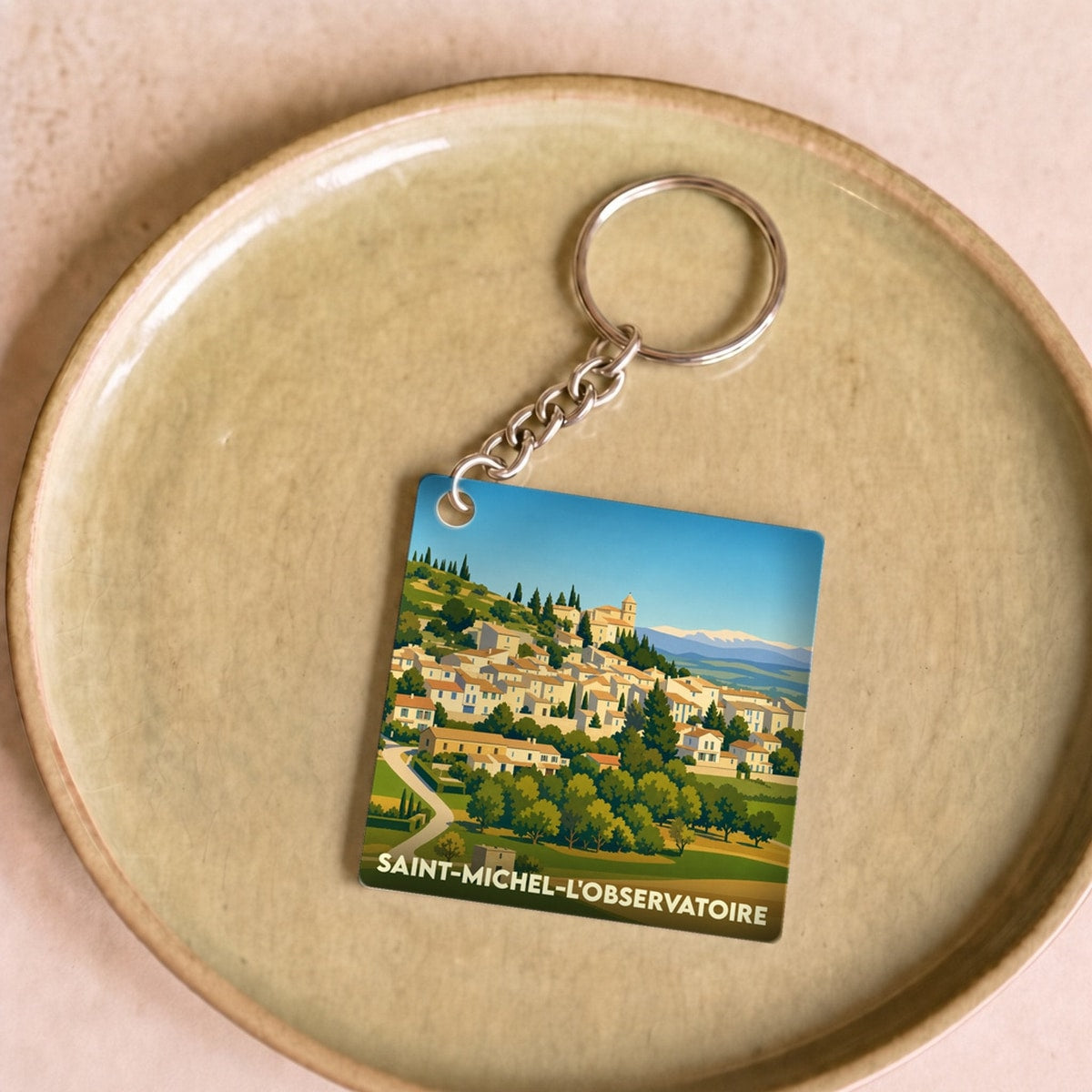 Porte-clés souvenir de la ville de Saint-Michel-l'Observatoire avec une illustration stylisée.