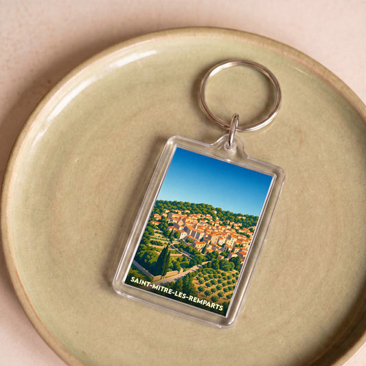 Porte-clés souvenir de la ville de Saint-Mitre-les-Remparts avec une illustration stylisée.