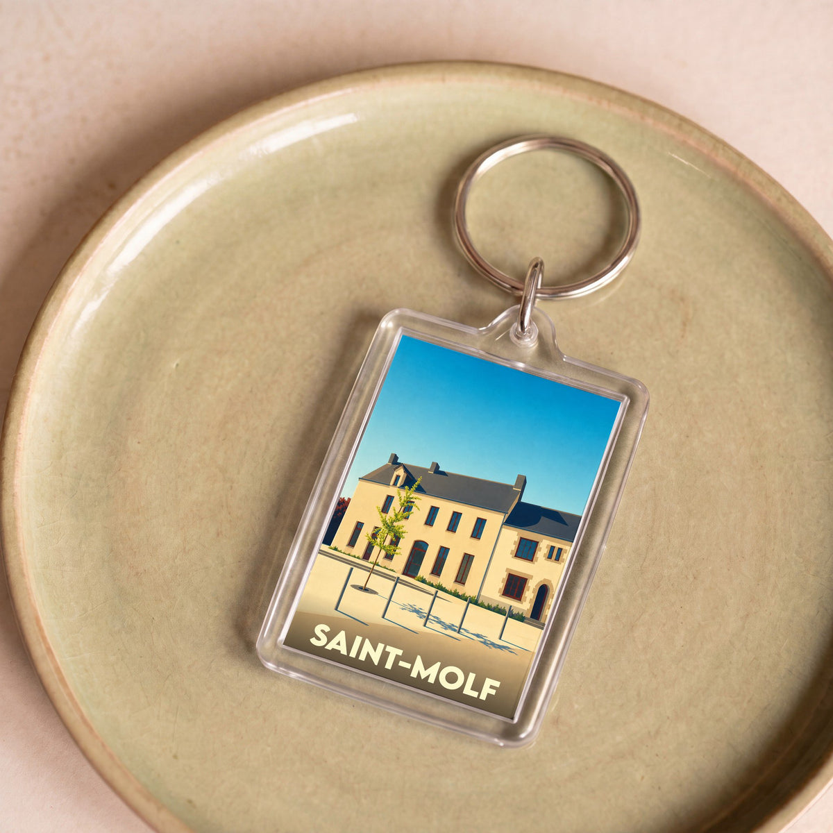 Porte-clés souvenir de la ville de Saint-Molf avec une illustration stylisée.