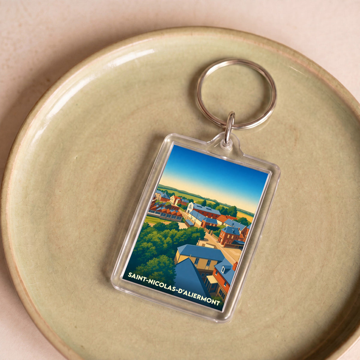 Porte-clés souvenir de la ville de Saint-Nicolas-d'Aliermont avec une illustration stylisée.