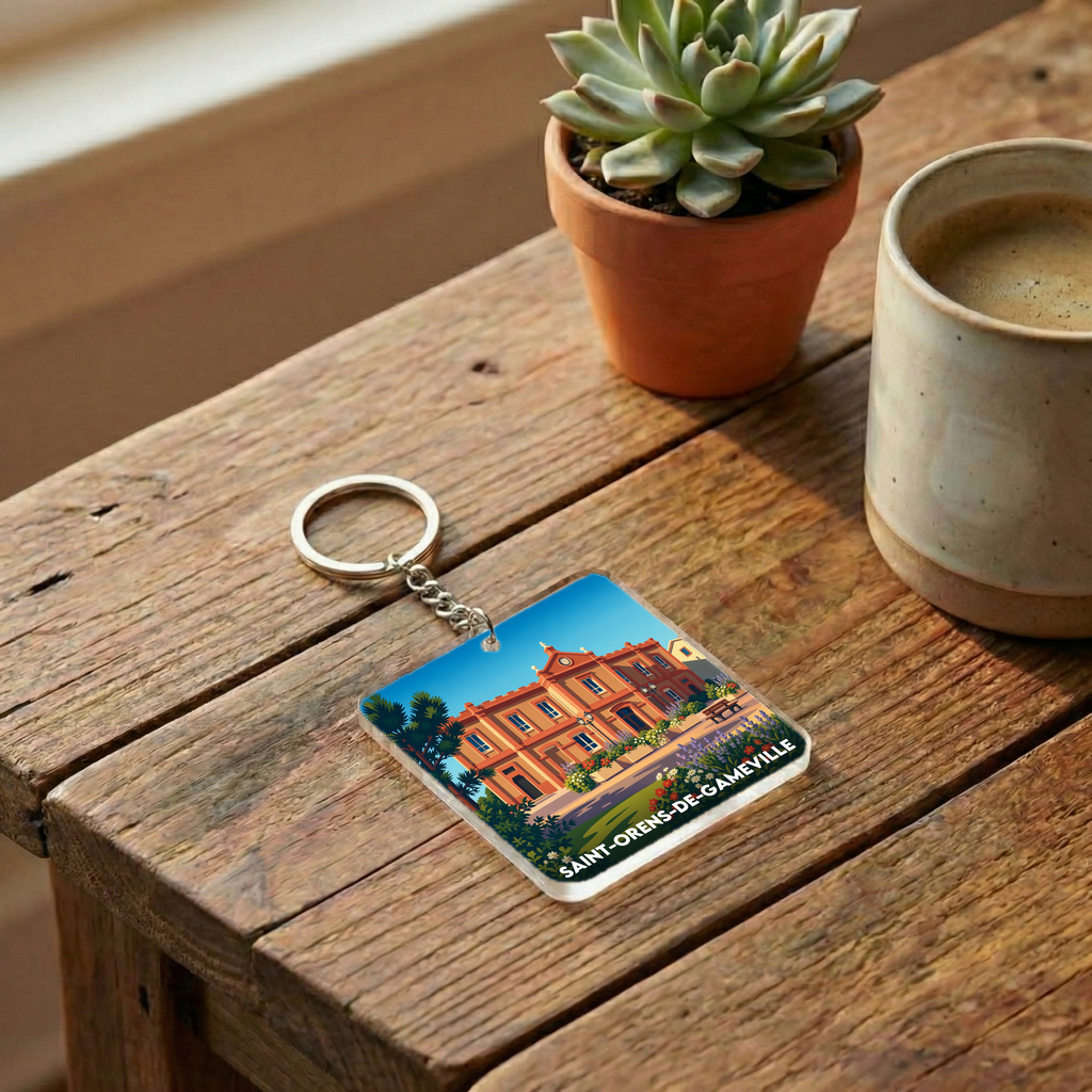 Porte-clés souvenir de la ville de Saint-Orens-de-Gameville avec une illustration stylisée.