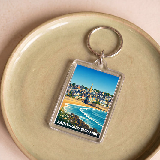 Porte-clés souvenir de la ville de Saint-Pair-sur-Mer avec une illustration stylisée du bord de mer.