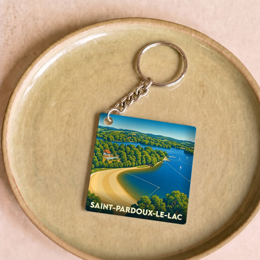 Porte-clés souvenir de Saint-Pardoux-le-Lac avec une illustration stylisée d'un lac et de sa plage.