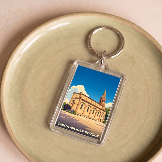 Porte-clés souvenir de la ville de Saint-Paul-Cap-de-Joux avec une illustration stylisée de son église.