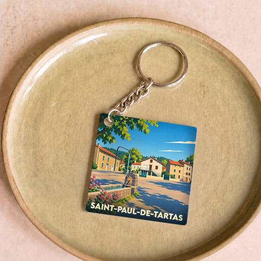 Porte-clés souvenir de la ville de Saint-Paul-de-Tartas avec une illustration stylisée.