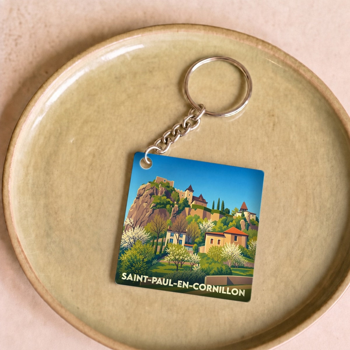 Porte-clés souvenir de la ville de Saint-Paul-en-Cornillon avec une illustration stylisée.