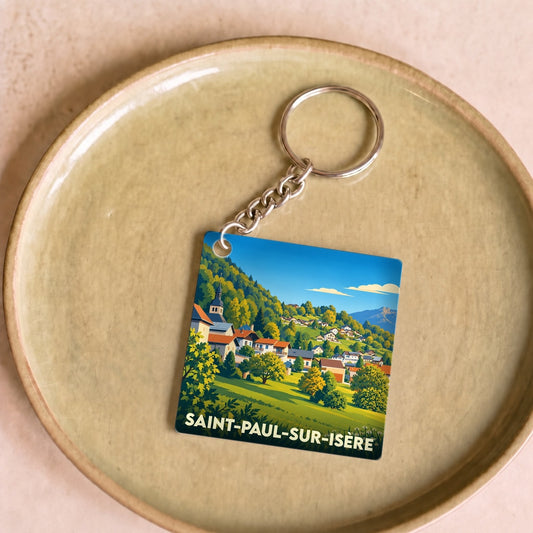 Porte-clés souvenir de la ville de Saint-Paul-sur-Isère avec une illustration paysagère stylisée.