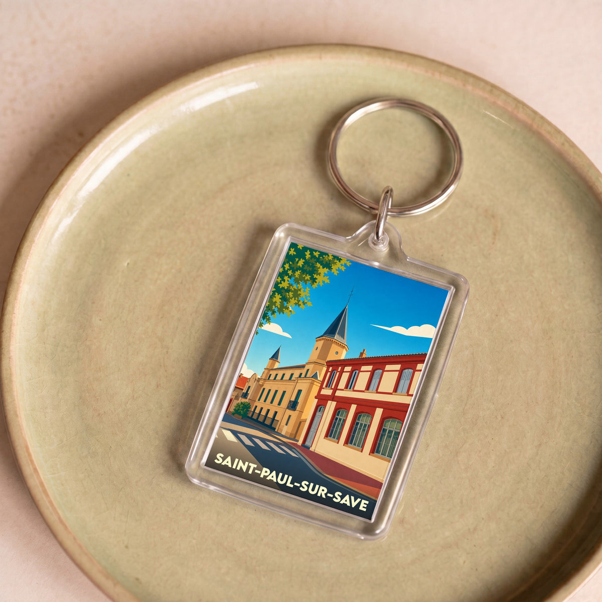 Porte-clés souvenir de la ville de Saint-Paul-sur-Save avec une illustration stylisée.