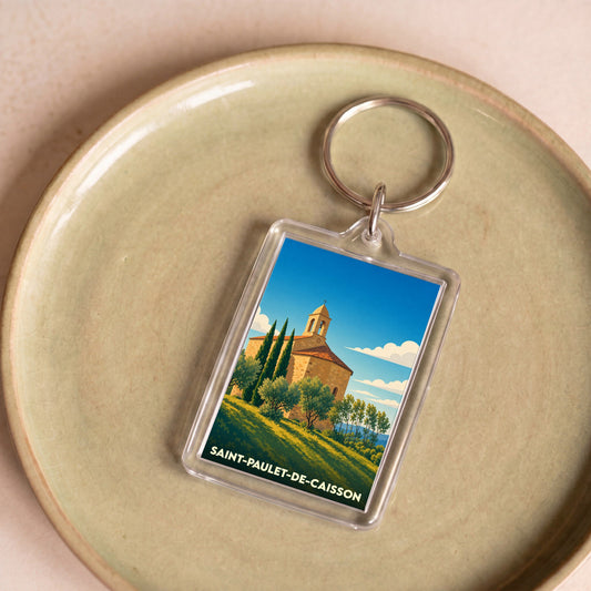 Porte-clés souvenir de la ville de Saint-Paulet-de-Caisson avec une illustration stylisée.