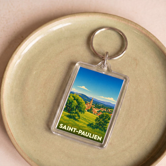 Porte-clés souvenir de la ville de Saint-Paulien avec une illustration paysagère stylisée.