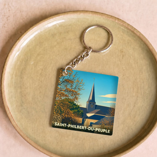 Porte-clés souvenir de la ville de Saint-Philbert-du-Peuple avec une illustration stylisée.