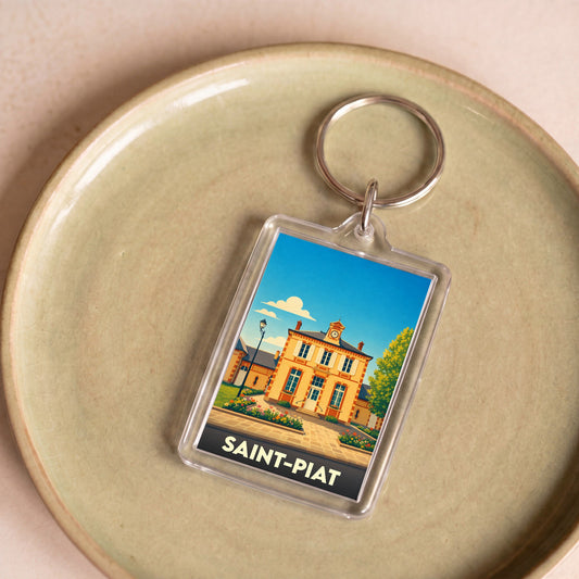 Porte-clés souvenir de la ville de Saint-Piat avec une illustration stylisée de sa mairie.