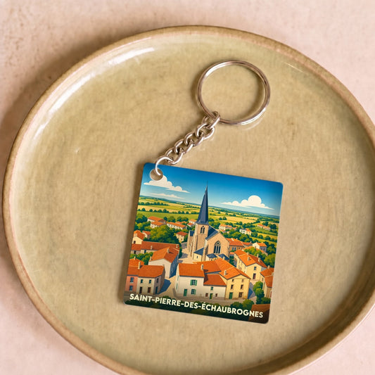 Porte-clés souvenir de Saint-Pierre-des-Échaubrognes avec une illustration stylisée de l'église et du village.